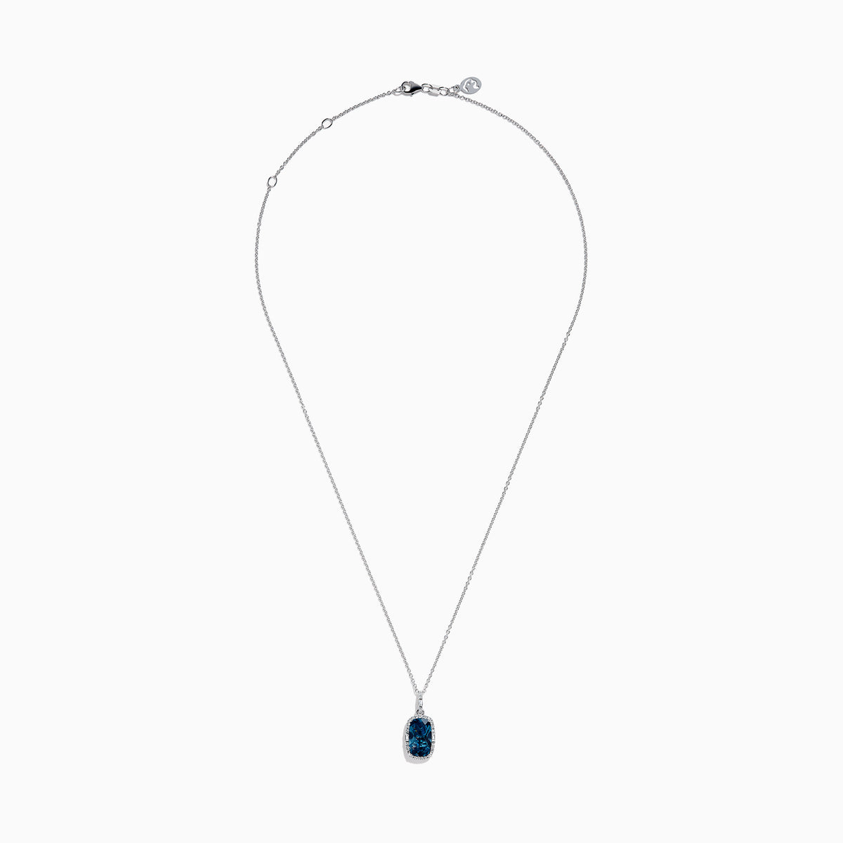 A 14 karat white gold necklace featuring an elongated cushion blue topaz and diamond pendant, set in an elegant frame.