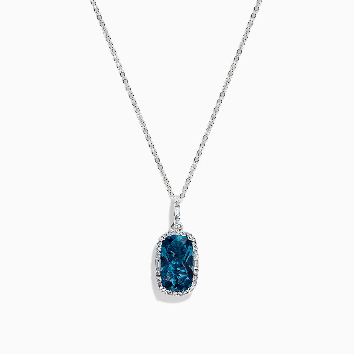 A 14 karat white gold necklace featuring an elongated cushion blue topaz and diamond pendant, set in an elegant frame.
