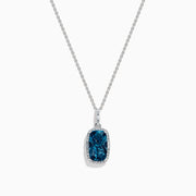 A 14 karat white gold necklace featuring an elongated cushion blue topaz and diamond pendant, set in an elegant frame.