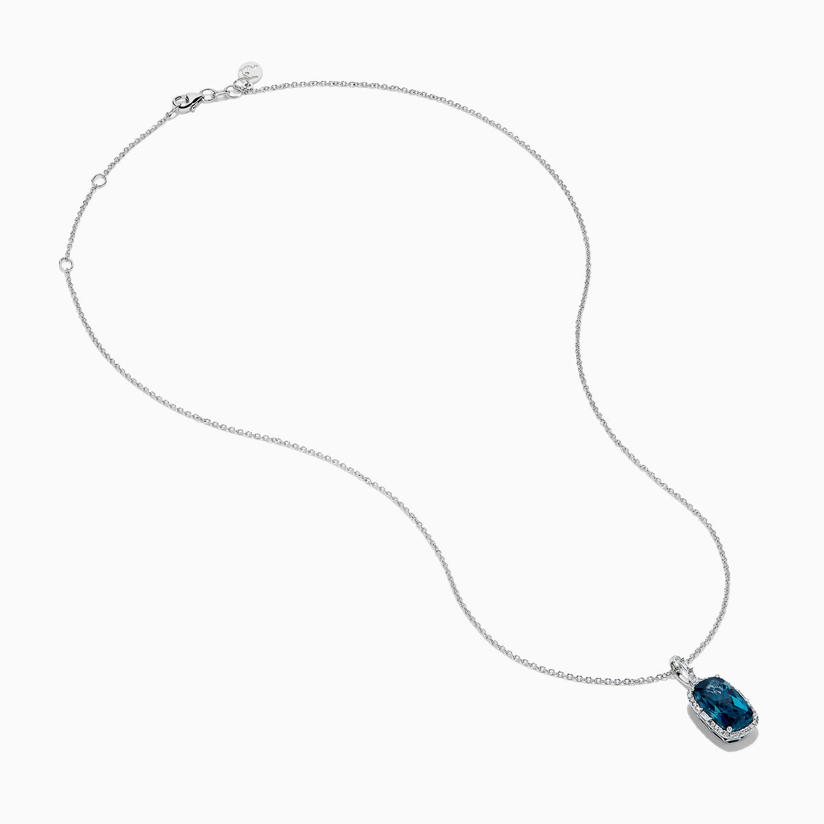 A 14 karat white gold necklace featuring an elongated cushion blue topaz and diamond pendant, set in an elegant frame.