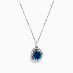 The Ocea Bleu 14K White Gold Blue Topaz and Diamond Pendant showcases a round blue topaz encircled by small diamonds, hanging from a delicate chain against a white background.