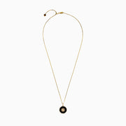 The Novelty 14K Yellow Gold Onyx and Diamond Compass Disc Pendant features a round onyx-black center, star-shaped design with a central diamond, and a border of small white stones on a gold chain. Plain white background.