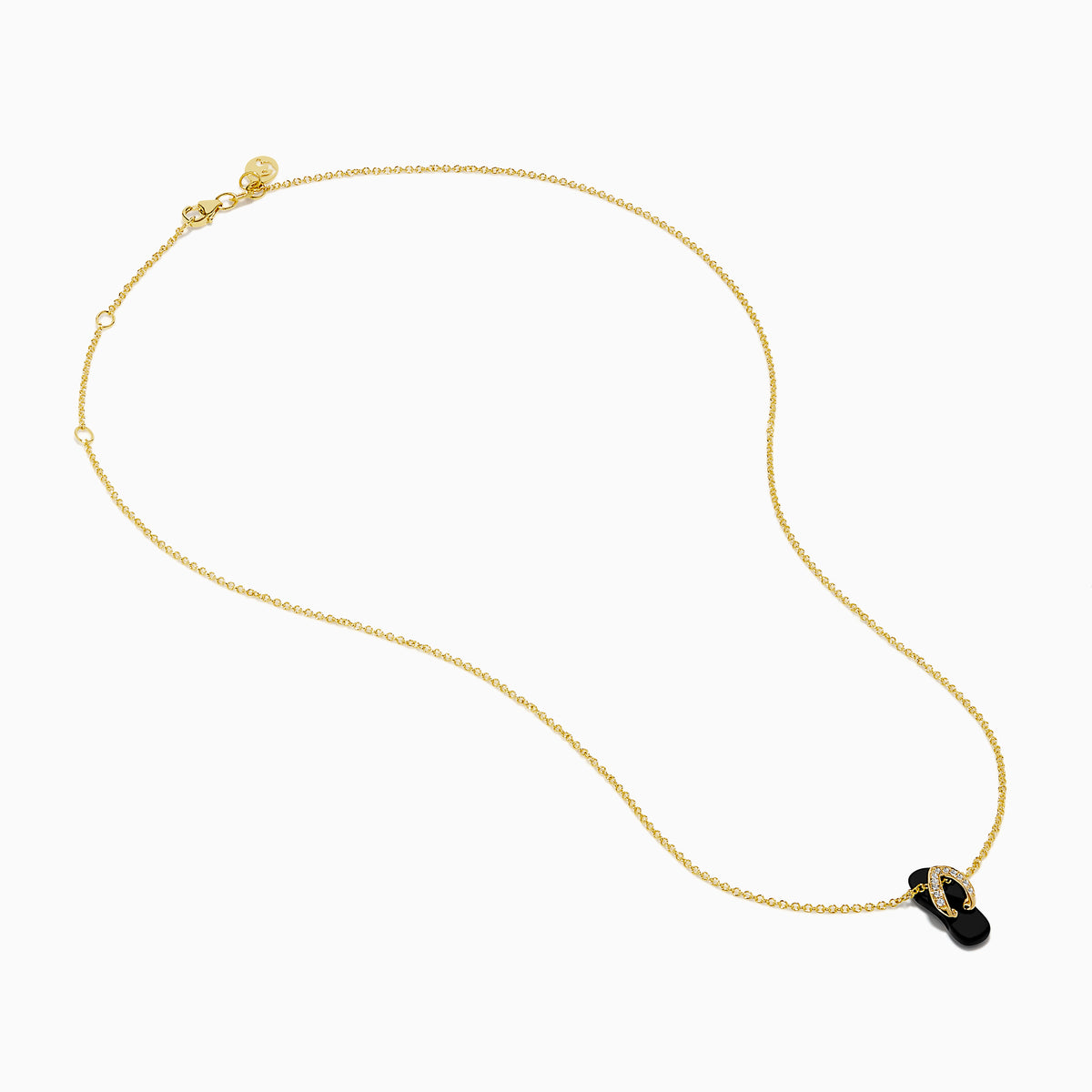 A delicate 14K yellow gold necklace features a flip flop pendant accented with onyx and diamonds, displayed against a white background.