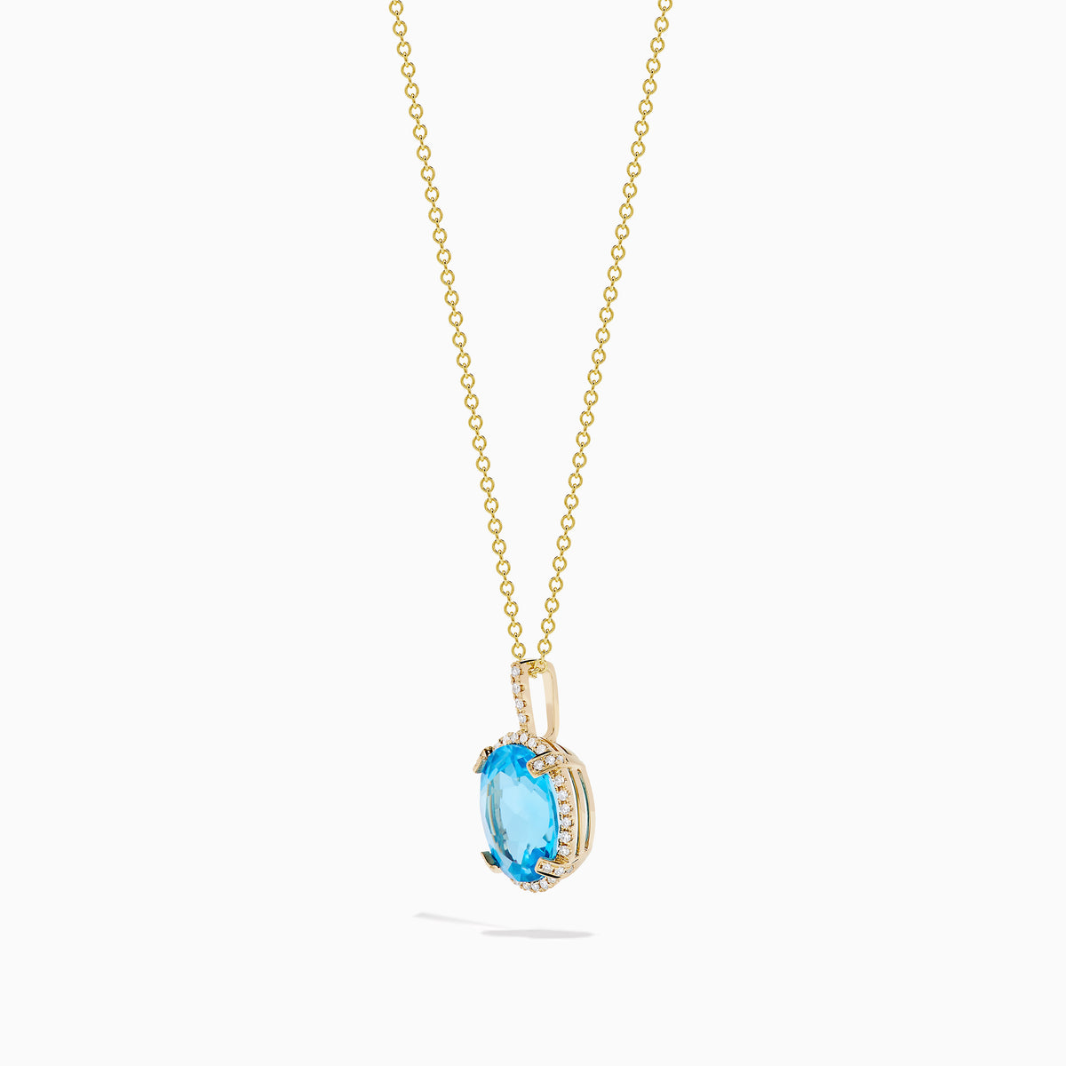 The Ocean Bleu 14K Yellow Gold Blue Topaz and Diamond Pendant features an oval blue topaz surrounded by sparkling diamonds on a gold chain, displayed against a white background.