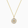 The Novelty 14K Yellow Gold Mother of Pearl and Diamond Compass Pendant features a polished circular charm with an eight-pointed star design, delicate chain, diamond accents, and mother of pearl inlay for added elegance.