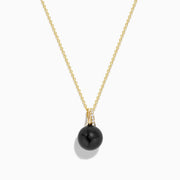 The 14K Yellow Gold Black Tahitian Pearl and Diamond Pendant features a black Tahitian pearl and a vertical row of diamonds on the bail, shown on a white background.