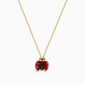 The 14K Yellow Gold Red Agate and Black Diamond Ladybug Pendant features red wings, black spots, and a black body, displayed against a white background.