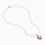 The Aurora 14K Yellow Gold Pendant features an ornate oval opal center, accented by diamonds and multi color sapphires in a decorative pattern on a gold chain necklace.