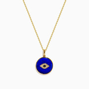 14K Yellow Gold Lapis and Diamond Evil Eye Disc Pendant features a gold chain and round pendant with a central evil eye design crafted from lapis and diamonds, set against a white background.