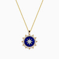 The Seaside 14K Yellow Gold Lapis and Diamond Compass Pendant features a gold chain and round lapis blue pendant with a white starburst design, accented by small gold beads, evoking a compass style. Shown on a plain white background.