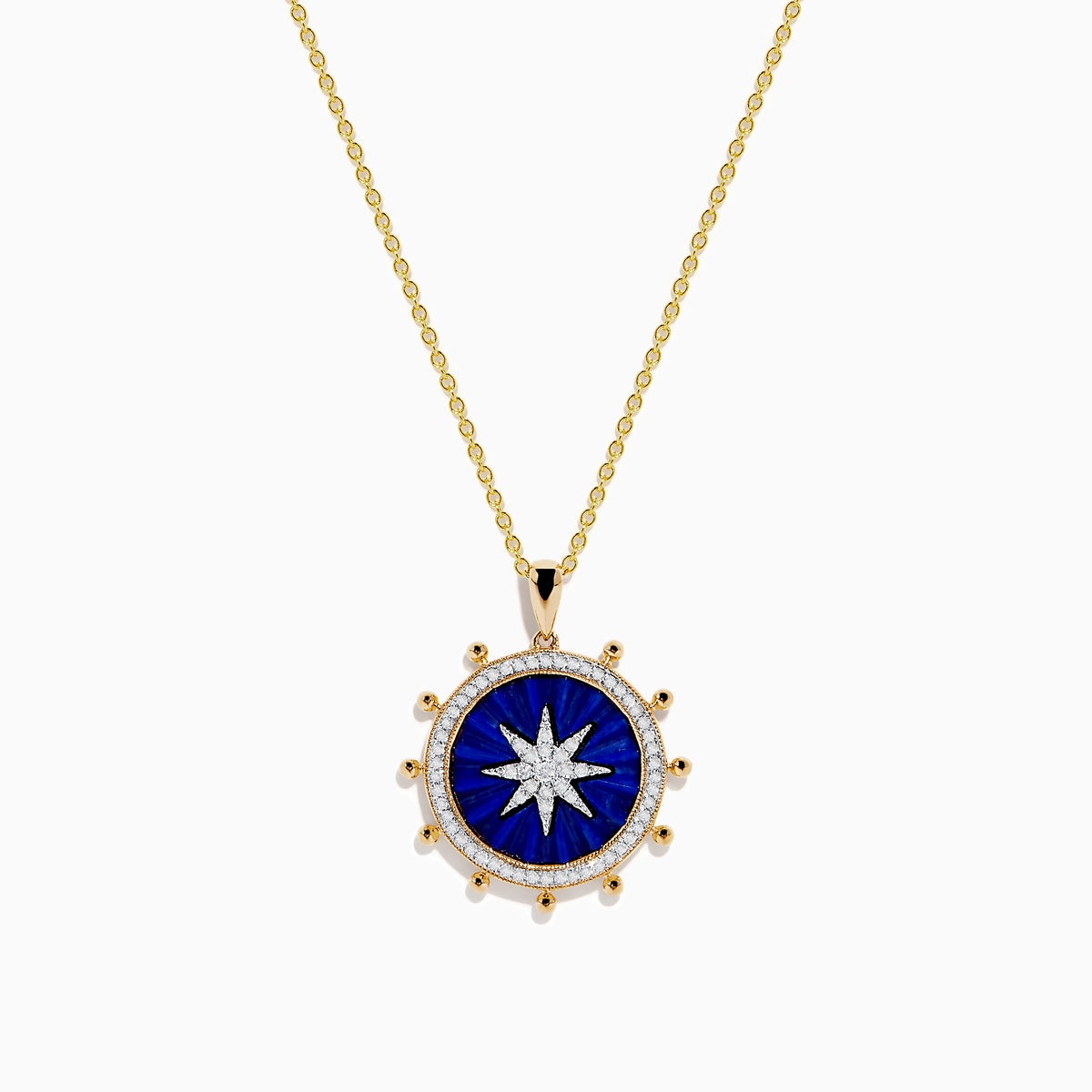 The Seaside 14K Yellow Gold Lapis and Diamond Compass Pendant features a gold chain and round lapis blue pendant with a white starburst design, accented by small gold beads, evoking a compass style. Shown on a plain white background.