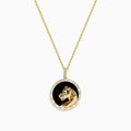 The Signature 14K Yellow Gold Onyx Emerald and Diamond Panther Pendant features a round onyx background, a detailed gold panther with an emerald green gemstone eye, and is surrounded by sparkling diamonds.
