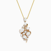 The Aurora 14K Yellow Gold Opal and Diamond Pendant features clustered white opal stones and small diamonds set in gold, creating an organic, elegant design on a yellow gold chain necklace.