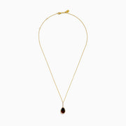 The 14K Yellow Gold Ammolite and Diamond Pendant features a pear-shaped Ammolite accented with small diamonds, set in yellow gold.