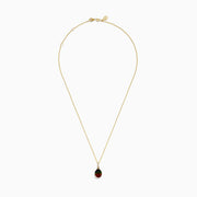 The 14K Yellow Gold Ammolite and Diamond Pendant features a faceted oval ammolite in dark iridescent hues, accented by rectangular diamonds above the gem. Shown on a white background.
