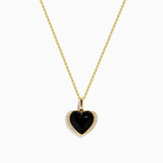 The 14K Yellow Gold Onyx and Diamond Heart Pendant features a glossy black onyx center surrounded by sparkling diamonds, all set on a yellow gold chain necklace.