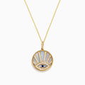 A 14K yellow gold necklace featuring a Mother of Pearl Evil Eye pendant, accented with diamonds and a sapphire gemstone, shown against a white background.