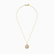 A 14K yellow gold necklace featuring a Mother of Pearl Evil Eye pendant, accented with diamonds and a sapphire gemstone, shown against a white background.