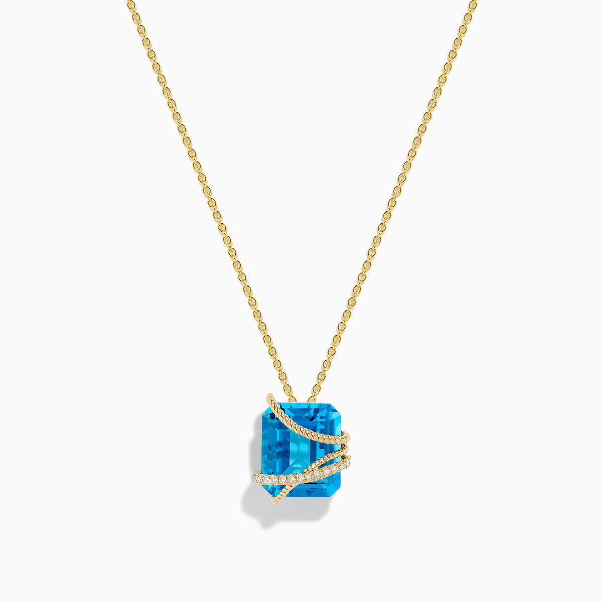 The Ocean Bleu 14K Yellow Gold Blue Topaz Pendant features a square-cut blue topaz wrapped in a diagonal gold band set with small white diamonds, displayed on a plain white background.