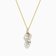 A 14K yellow gold necklace featuring a pendant with an oval and teardrop-shaped white topaz and diamond, stacked vertically for an elegant look.