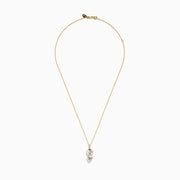 A 14K yellow gold necklace featuring a pendant with an oval and teardrop-shaped white topaz and diamond, stacked vertically for an elegant look.