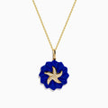 The Seaside 14K Yellow Gold Lapis and Diamond Starfish Pendant features a lapis flower-shaped design and a diamond-accented starfish with white crystal details at the center.
