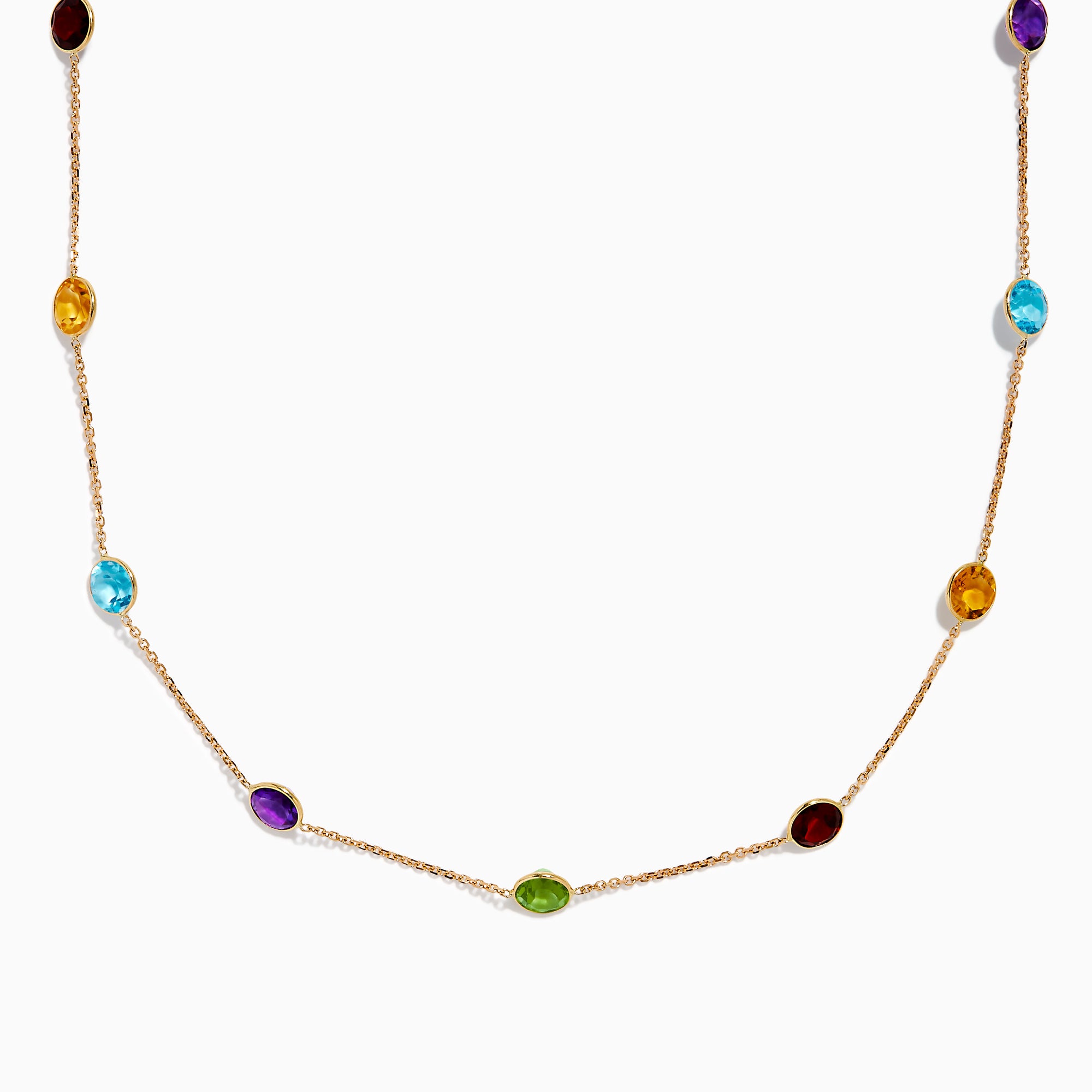 The 14K Rose Gold Multi Color Gemstone Station Necklace features evenly spaced oval gemstones in blue, green, purple, yellow, and red, shown against a white background.