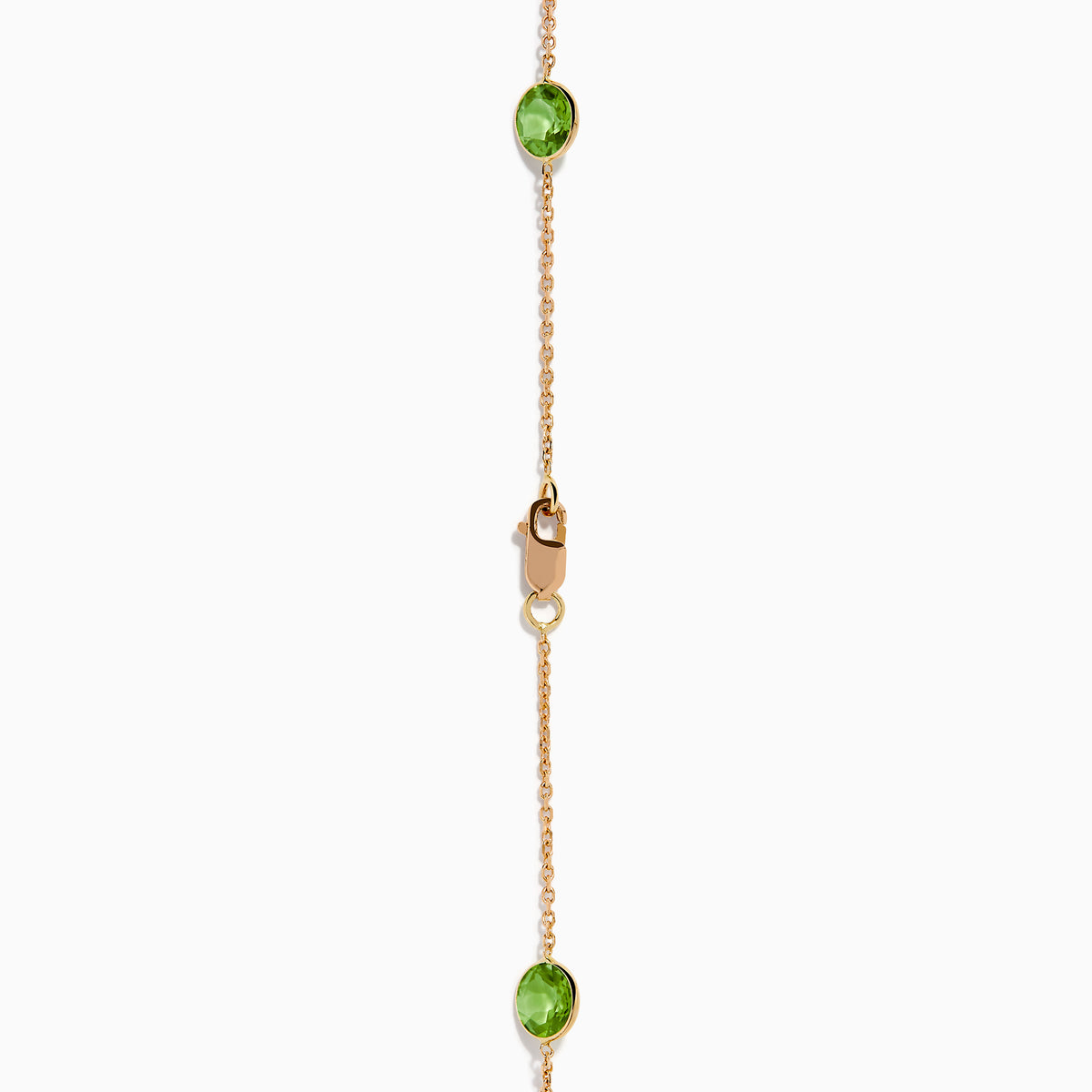 The 14K Rose Gold Multi Color Gemstone Station Necklace features evenly spaced oval gemstones in blue, green, purple, yellow, and red, shown against a white background.