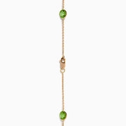 The 14K Rose Gold Multi Color Gemstone Station Necklace features evenly spaced oval gemstones in blue, green, purple, yellow, and red, shown against a white background.