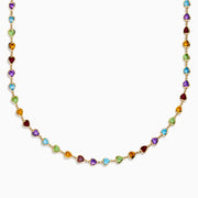 The 14K Yellow Gold Multi-Gemstone Bezel Heart Station Necklace showcases vibrant heart-shaped gemstones bezel-set and evenly spaced along a delicate yellow gold chain.