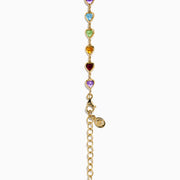 The 14K Yellow Gold Multi-Gemstone Bezel Heart Station Necklace showcases vibrant heart-shaped gemstones bezel-set and evenly spaced along a delicate yellow gold chain.