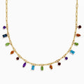 The 14K Yellow Gold Multi-Gemstone Paperclip Chain Fringe Necklace features vibrant gemstones in assorted shapes and sizes along a paperclip chain, beautifully displayed on a white background.