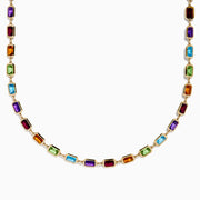 The 14K Yellow Gold Multi Color Gemstone Bezel Necklace features bezel-set rectangular purple, orange, green, and blue gemstones evenly spaced along the chain.