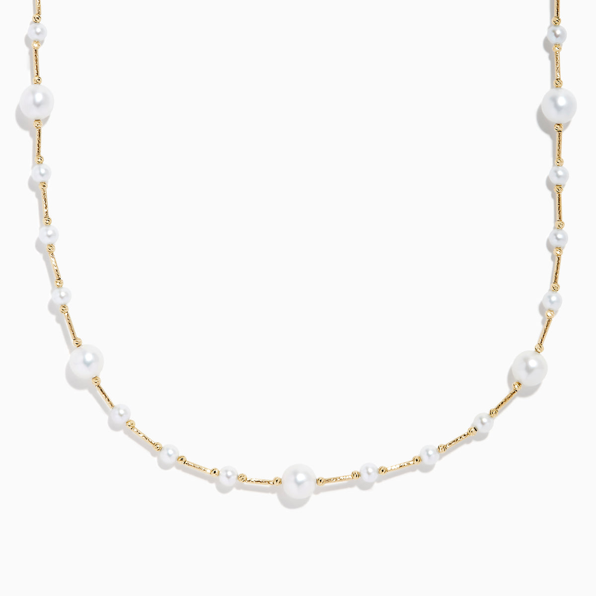 The 14K Yellow Gold Cultured Fresh Water Pearl Station Necklace features small, evenly spaced pearls along a fine gold chain for an elegant, minimalist look. Pearls vary slightly in size for added delicacy.
