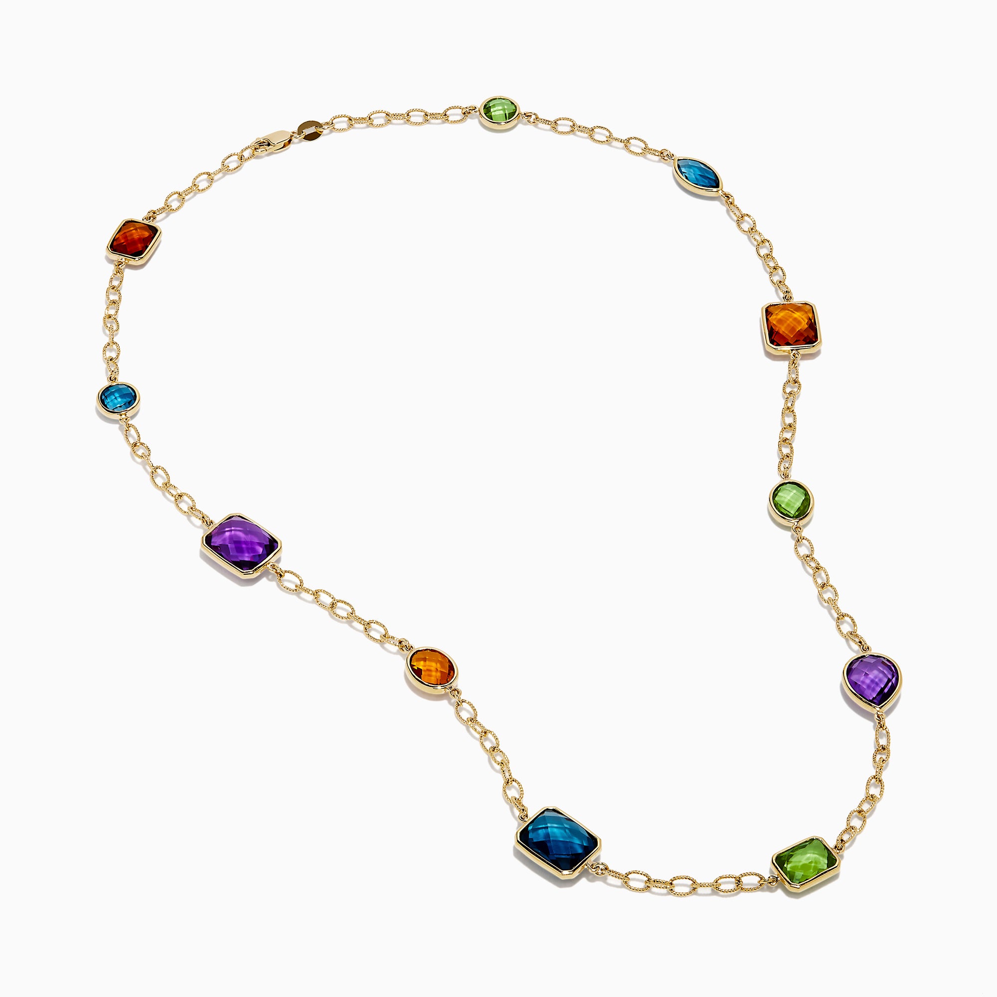 The 14K Yellow Gold Multi-Gemstone Mixed-Shape Station Necklace features seven bezel-set, faceted gemstones in vibrant orange, blue, green, and purple hues, elegantly spaced along the chain.