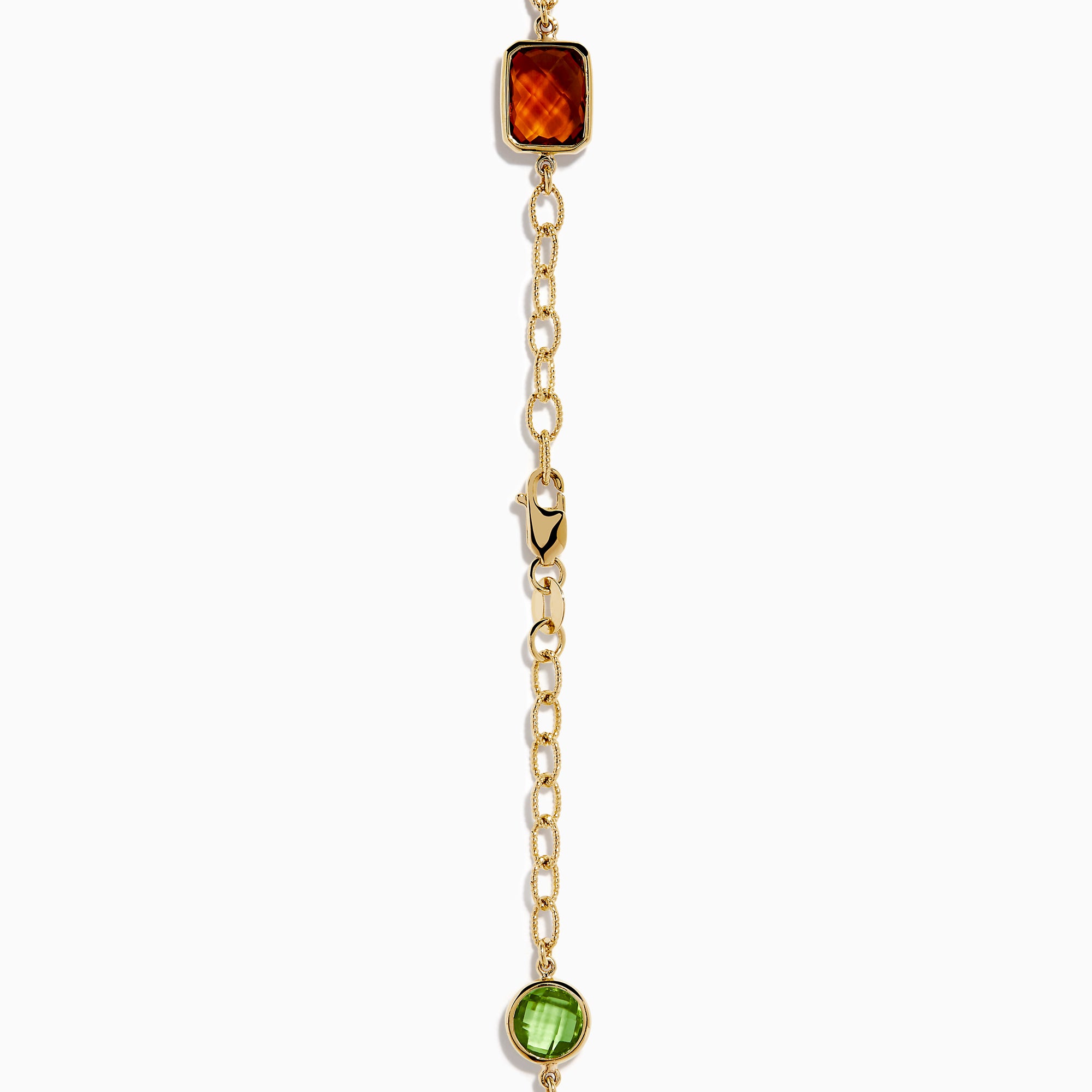 The 14K Yellow Gold Multi-Gemstone Mixed-Shape Station Necklace features seven bezel-set, faceted gemstones in vibrant orange, blue, green, and purple hues, elegantly spaced along the chain.