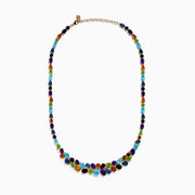 The Mosaic 14K Yellow Gold Multi Color Gemstone and Diamond Necklace showcases oval and teardrop-shaped blue, green, orange, purple, and dark red stones in a symmetrical design set in gold on a white background.