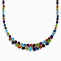 The Mosaic 14K Yellow Gold Multi Color Gemstone and Diamond Necklace showcases oval and teardrop-shaped blue, green, orange, purple, and dark red stones in a symmetrical design set in gold on a white background.