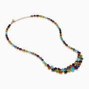 The Mosaic 14K Yellow Gold Multi Color Gemstone and Diamond Necklace showcases oval and teardrop-shaped blue, green, orange, purple, and dark red stones in a symmetrical design set in gold on a white background.