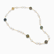 The 14K Yellow Gold Tahitian and Freshwater Pearl Necklace features alternating white and dark pearls on a delicate gold chain, beautifully displayed against a white background.