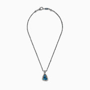 A 925 sterling silver and 18K yellow gold pendant with an ornate chain, featuring a triangular London blue and blue topaz set in an intricate frame.