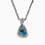A 925 sterling silver and 18K yellow gold pendant with an ornate chain, featuring a triangular London blue and blue topaz set in an intricate frame.