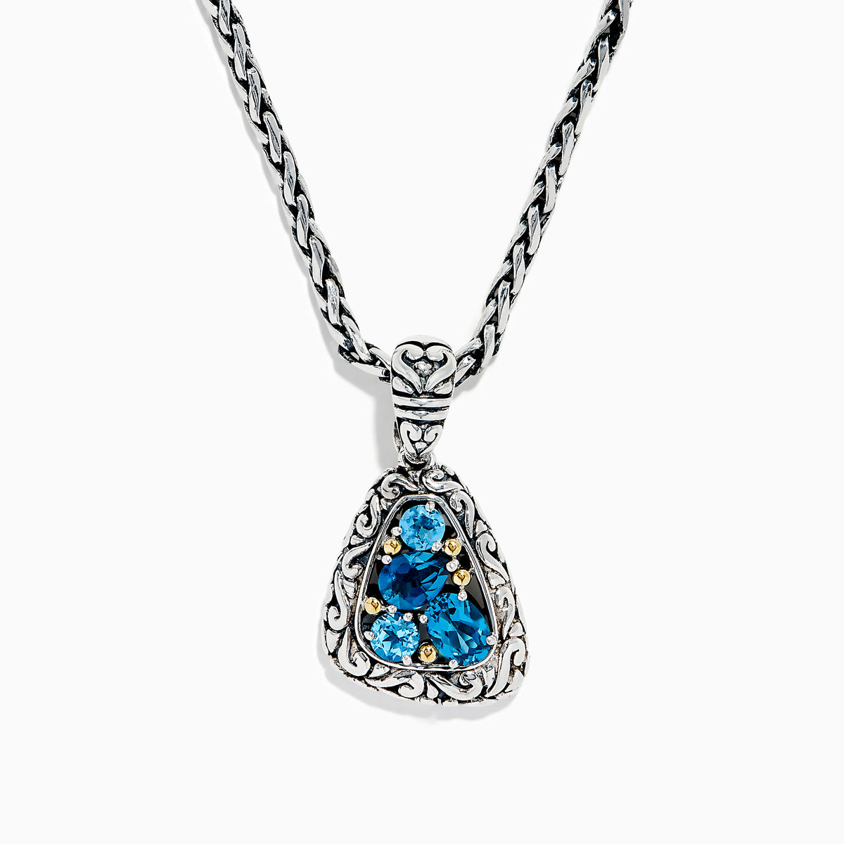 A 925 sterling silver and 18K yellow gold pendant with an ornate chain, featuring a triangular London blue and blue topaz set in an intricate frame.