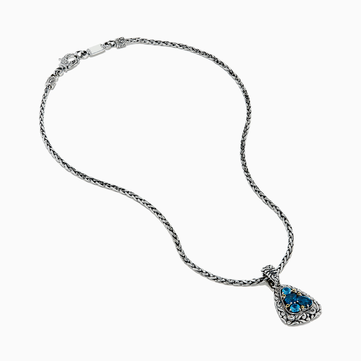A 925 sterling silver and 18K yellow gold pendant with an ornate chain, featuring a triangular London blue and blue topaz set in an intricate frame.