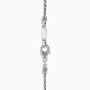 A 925 sterling silver and 18K yellow gold pendant with an ornate chain, featuring a triangular London blue and blue topaz set in an intricate frame.