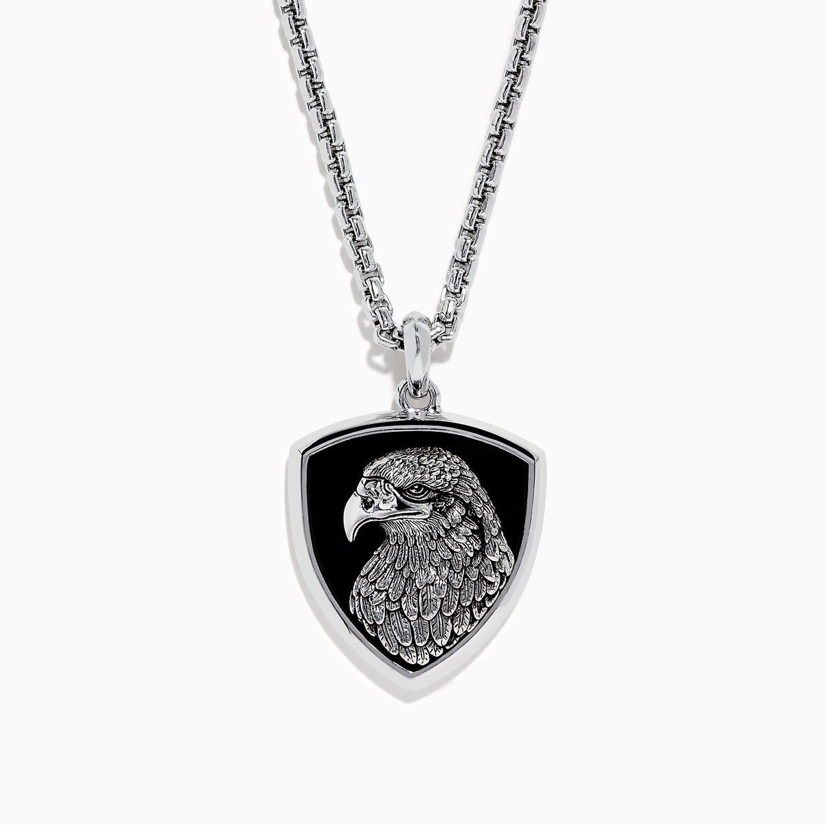 The Mens 925 Sterling Silver Onyx Pendant features a detailed engraved eagle head on a black shield-shaped background, crafted from sterling silver and suspended from a sleek silver chain.
