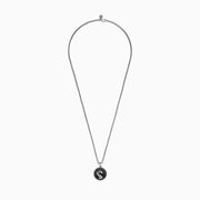 The Mens 925 Sterling Silver Black Spinel and Ruby Pendant features a round dragon design on a textured black background, with a small ruby as the dragons eye, suspended from a sterling silver chain necklace.