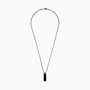 The Men's Sterling Silver Onyx Dog Tag Pendant features a simple rectangular onyx set in sterling silver, suspended from a chain and displayed against a plain white background.