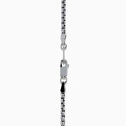 The Mens 925 Sterling Silver Onyx Pendant features a silver chain and a rectangular onyx pendant framed in silver, with a gold border and small gold studs accenting the top and bottom edges.