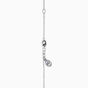 The Ocean Bleu 14K White Gold Blue Topaz and Diamond Pendant features a delicate chain and a four-petal flower blue topaz pendant accented with sparkling gemstones and a central diamond, set against a white background.